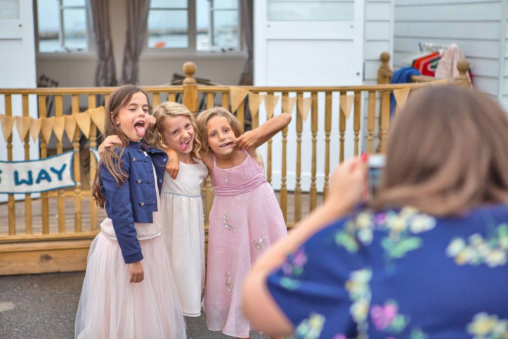 children pulling faces at a wedding