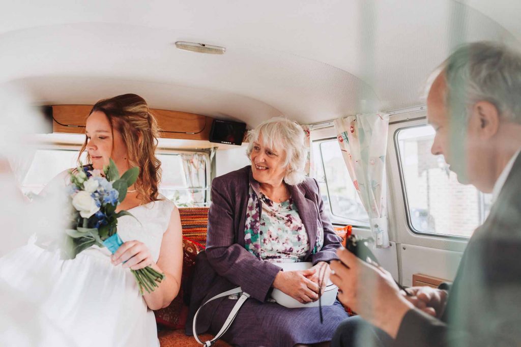 bride with family in wedding campervan