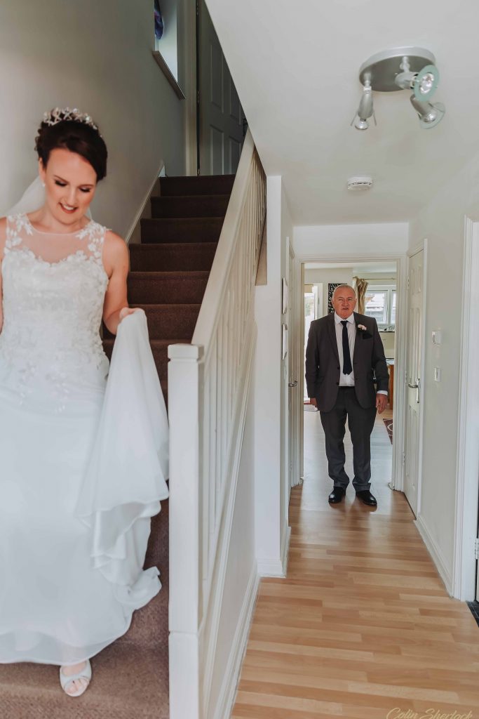 bride about to show her father her wedding dress for first time