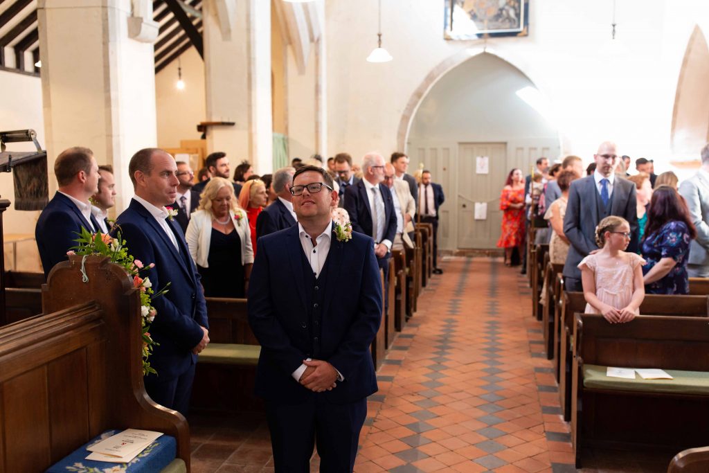 groom waiting for bride to enter in church