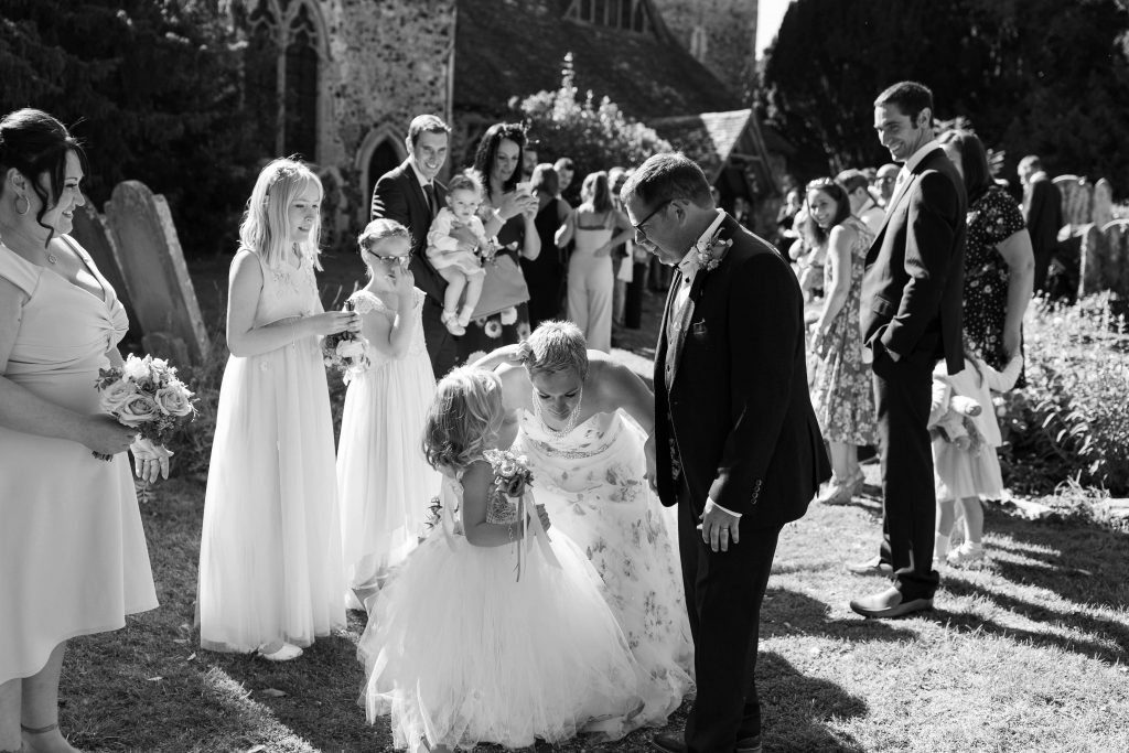 daughter picking confetti out of brides hair