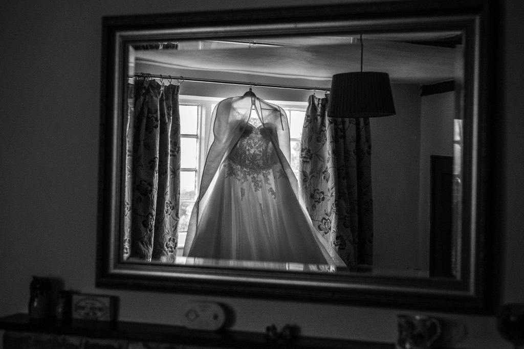 dress hanging up reflected in mirror