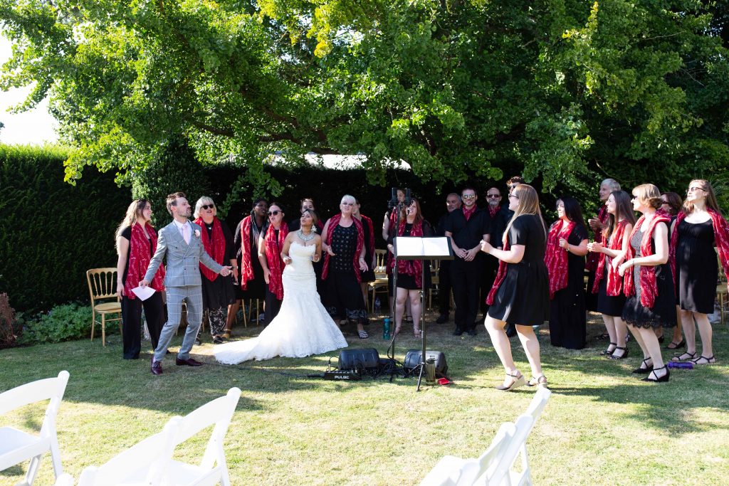 bride and groom singing with choir