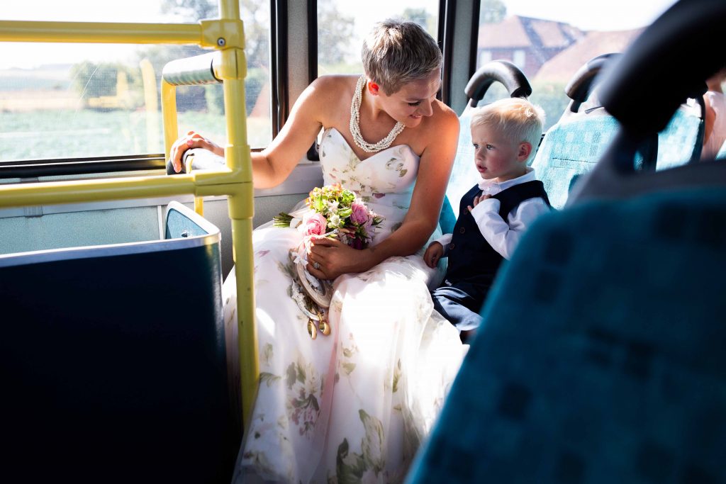 bride and young son on wedding bus