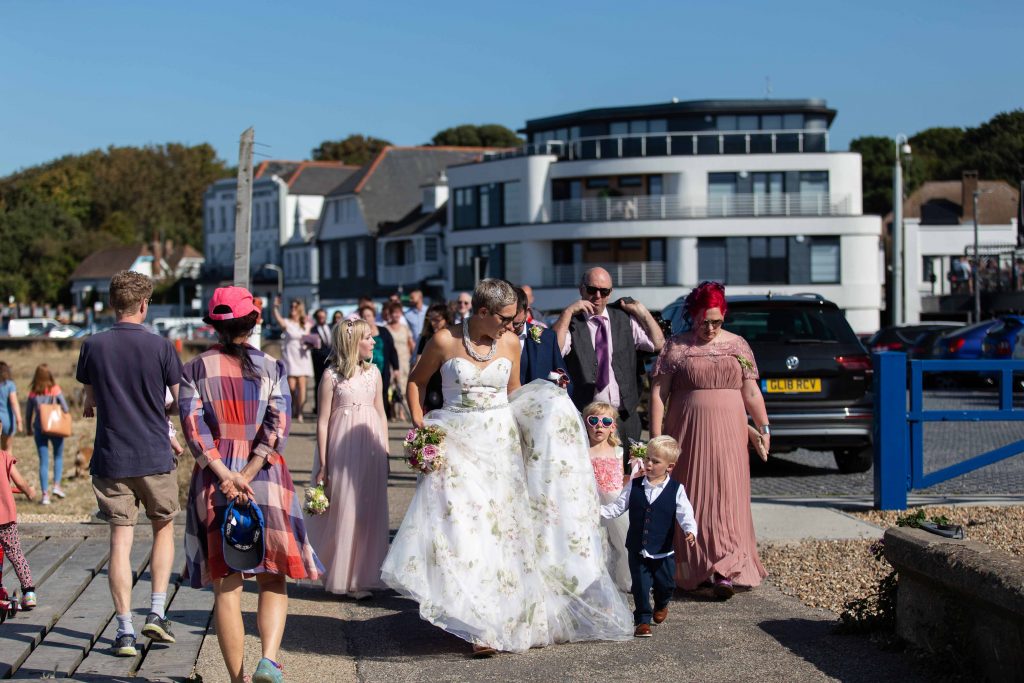 wedding party walking on Whitstable beachfront