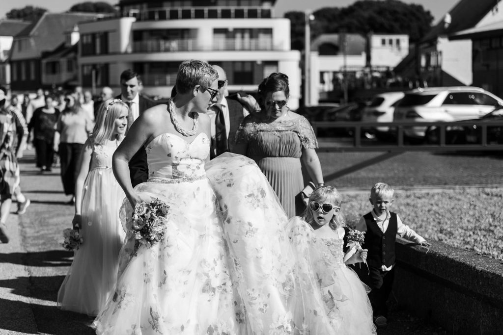 Wedding portrait walking on Whitstable beachfront