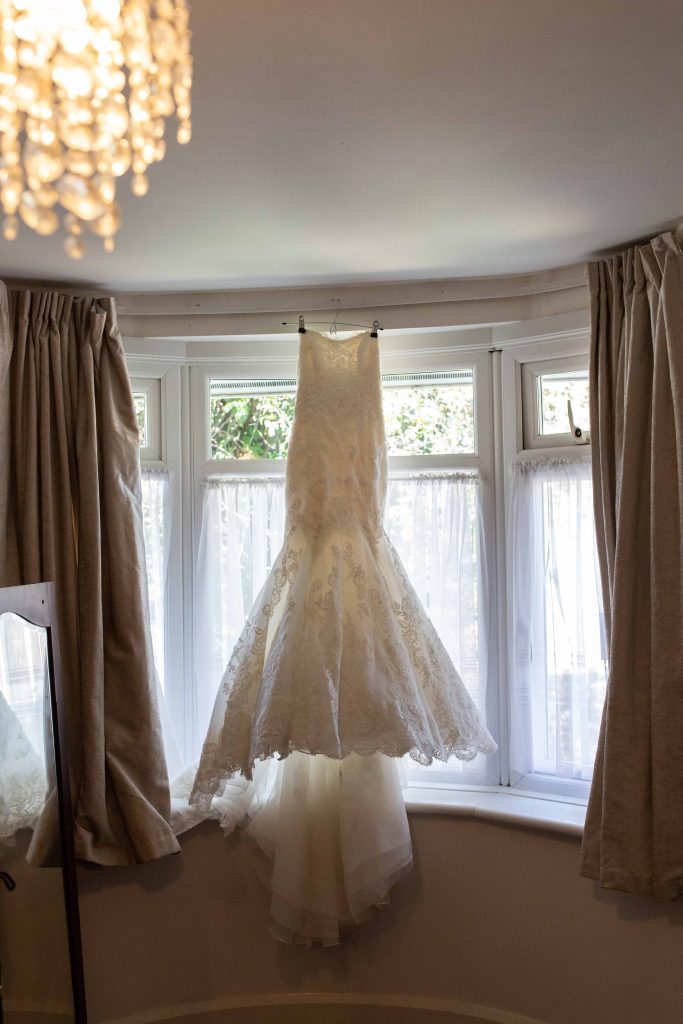 bridal dress hanging in window