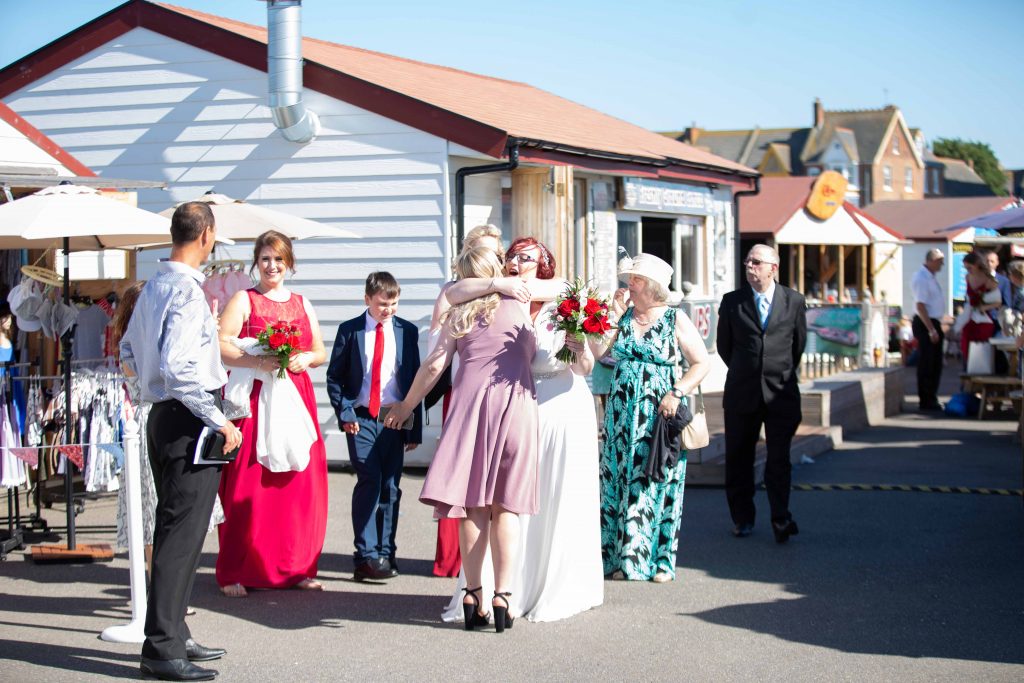 wedding guests at beach hut wedding venue on Herne bay pier