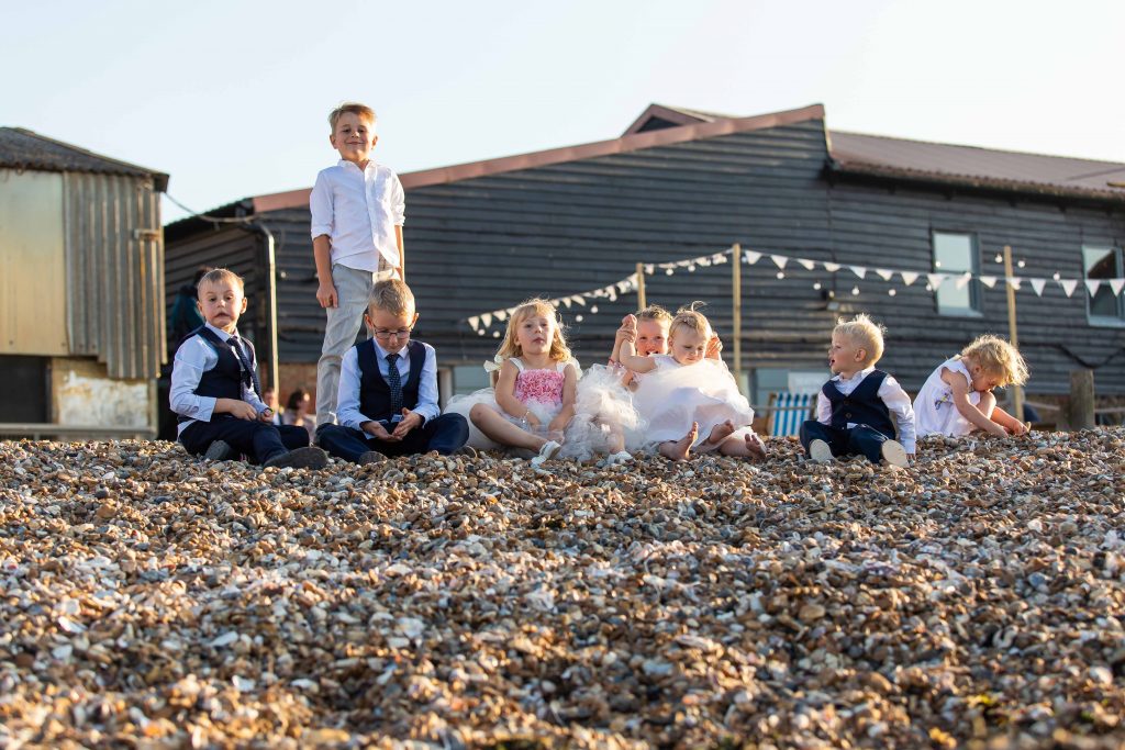 children on beach together at wedding at East Quay venue