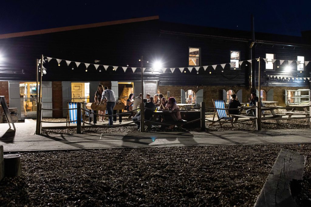 east quay wedding venue at night with guests outside