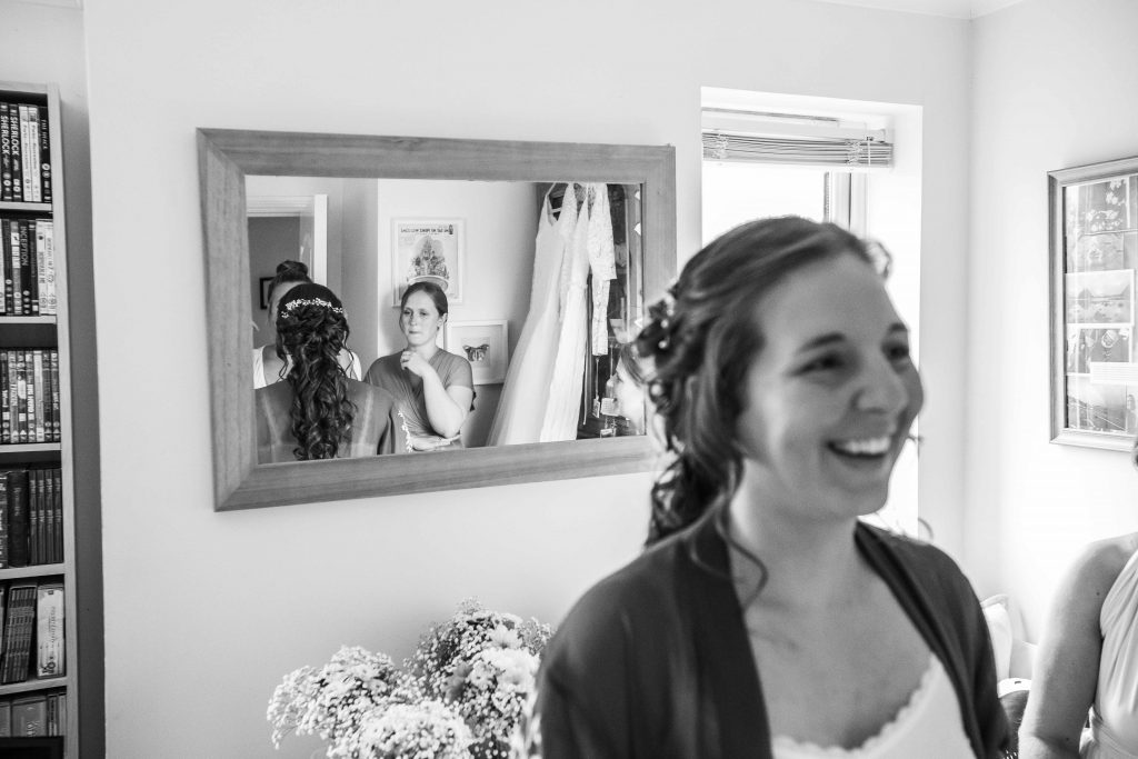 bride an bridesmaids reflected in mirror