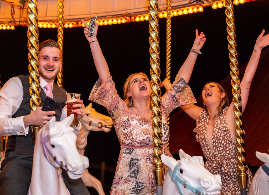 wedding guests on carousel at Preston court