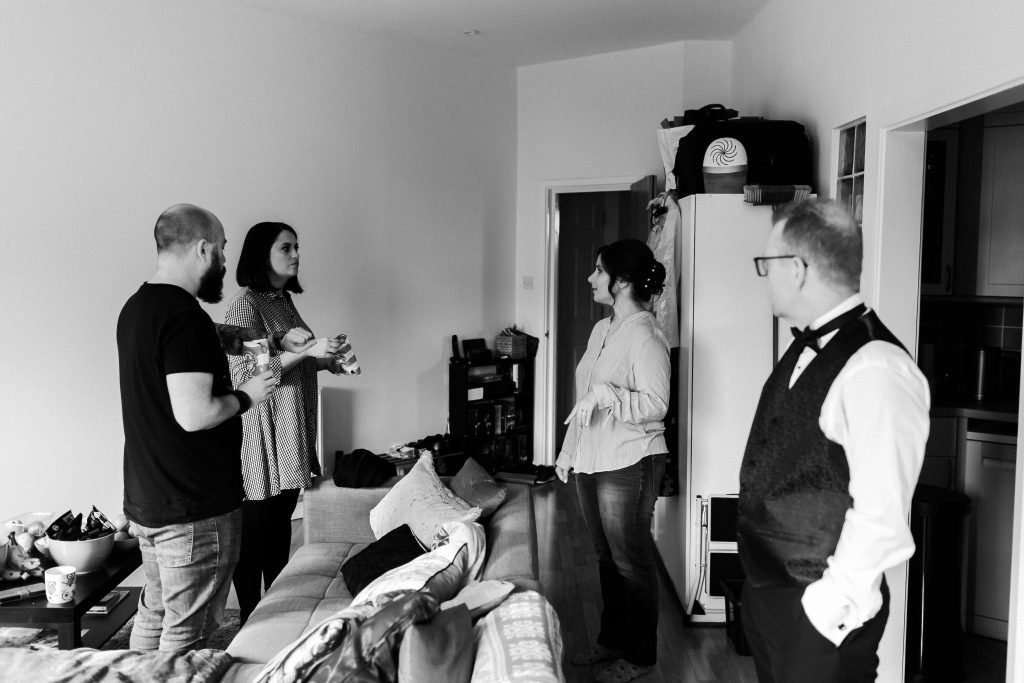 bride and groom with friends during wedding prep