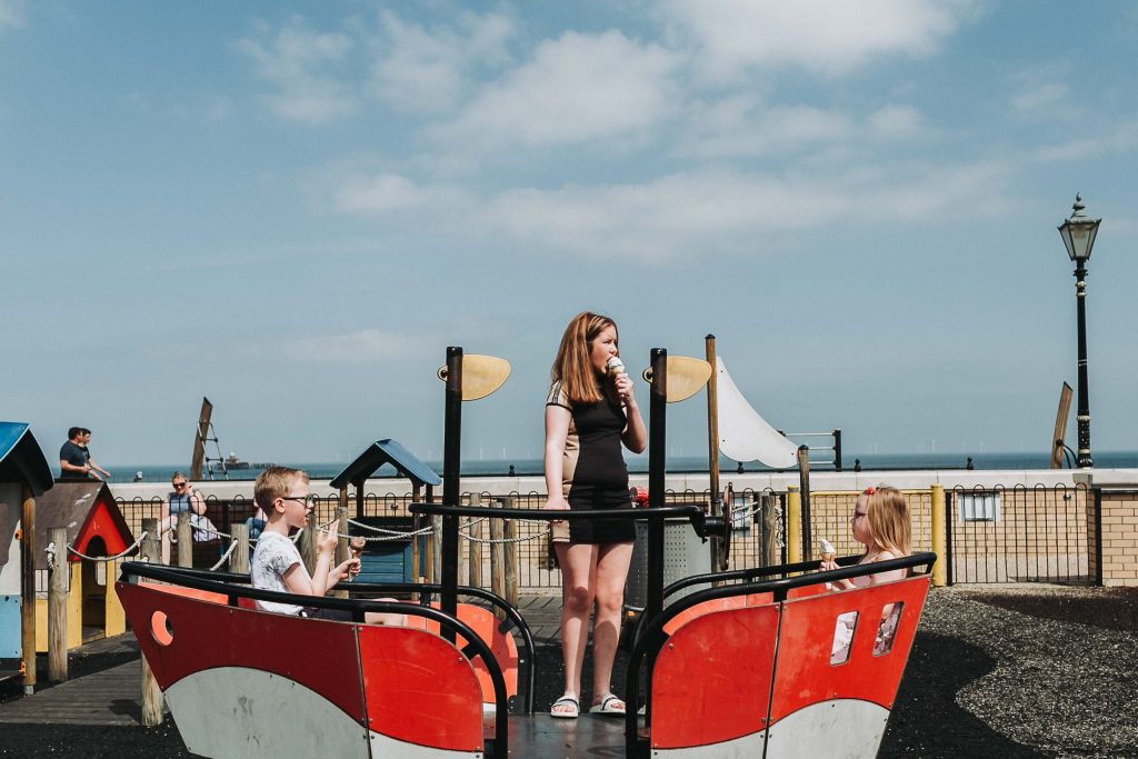 children in play park on boat for pre-wedding family shoot