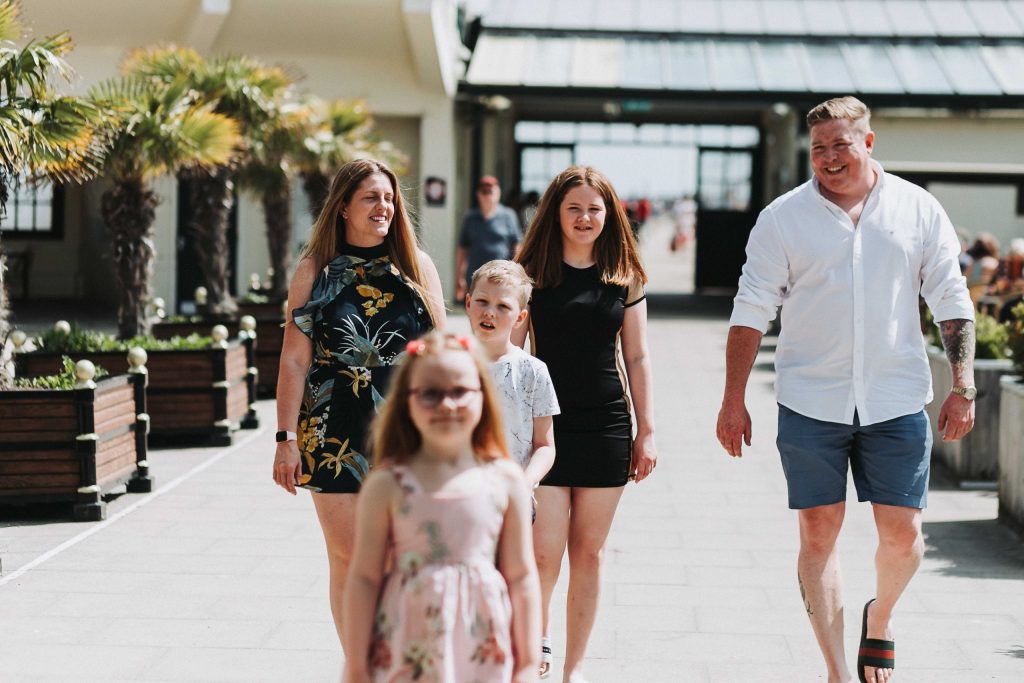 family walking towards camera smiling