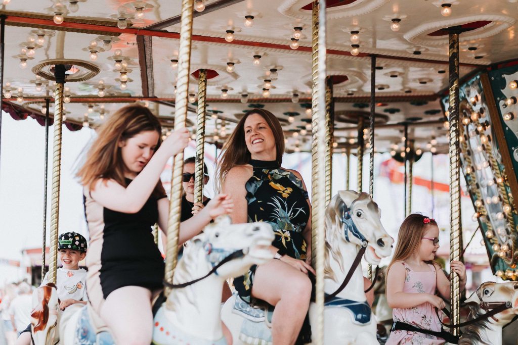 mum and daughters on carousel on herne bay pier