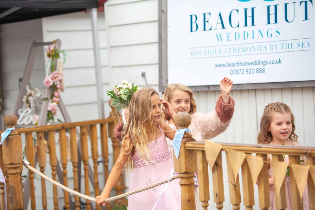 children at beach hut wedding venue