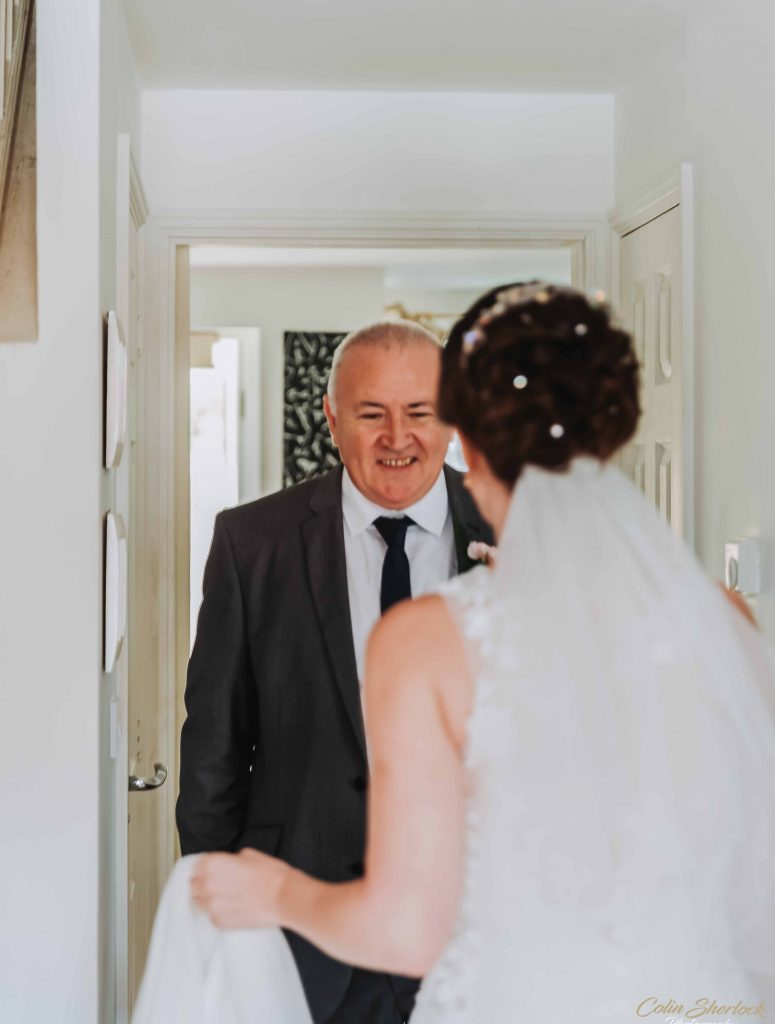 father seeing daughter in dress for first time
