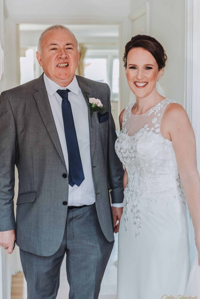 portrait of father and daughter in wedding dress