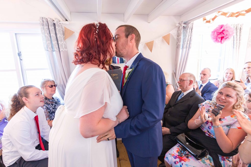bride and groom kiss at beach hut wedding ceremony herne bay