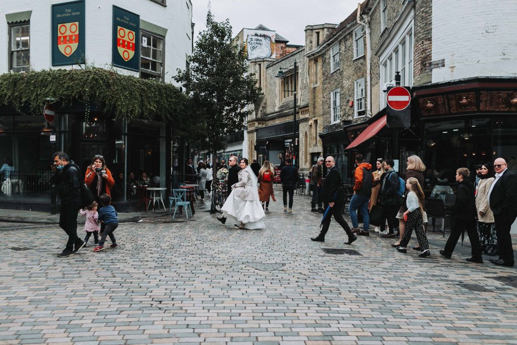 bride and groom walking to wedding venue through streets of Canterbury