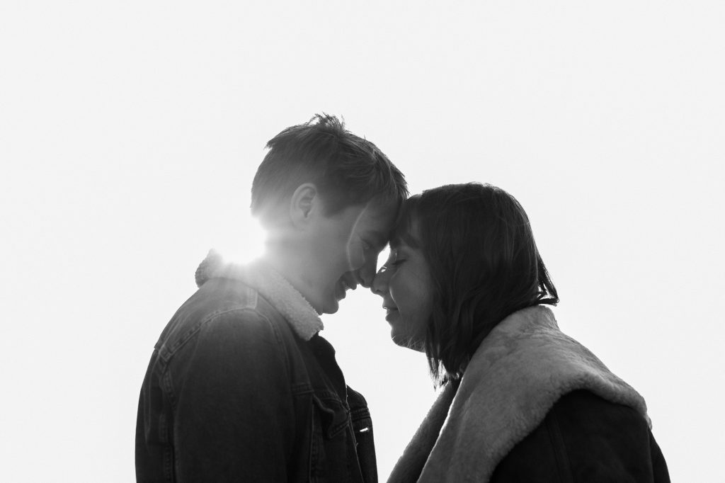 black and white couple portrait with sunflare