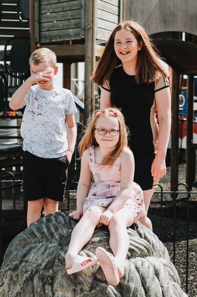 three children posing for camera