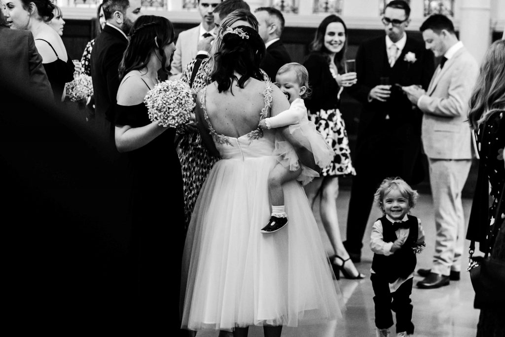 bride carrying her baby at wedding reception