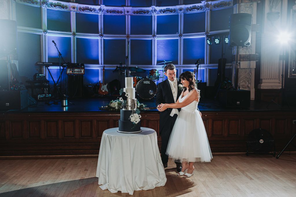 cake being cut at Old Finsbury Town Hall wedding