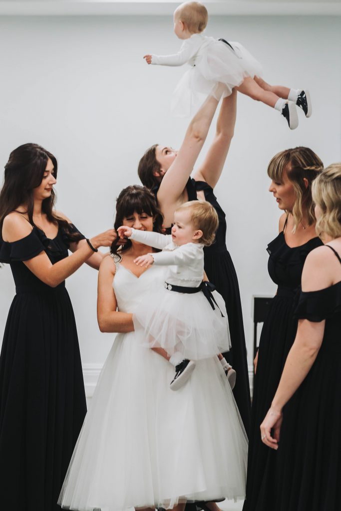 bride with bridesmaids and twin baby girls at london wedding