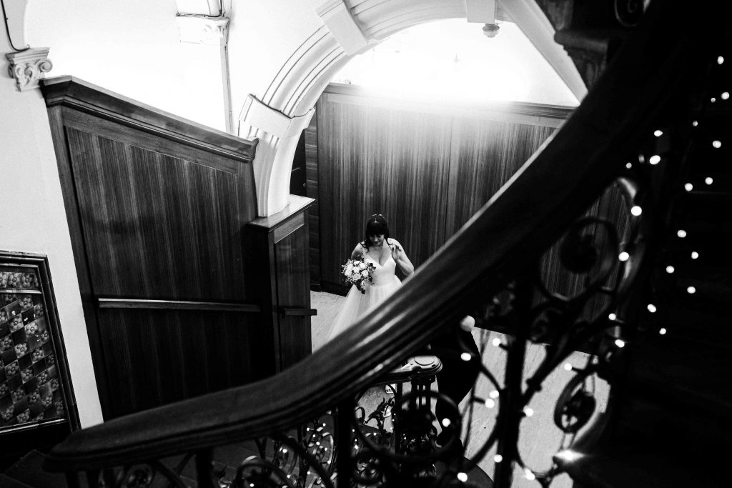 bride waiting at bottom of stairs