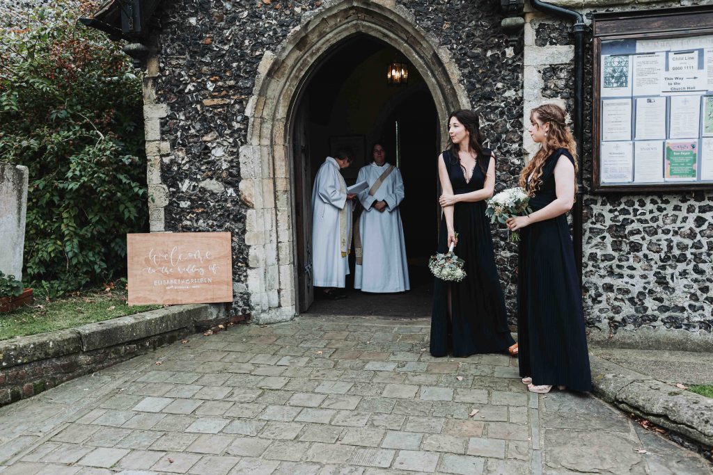 bridesmaids waiting for arrival of bride outside church