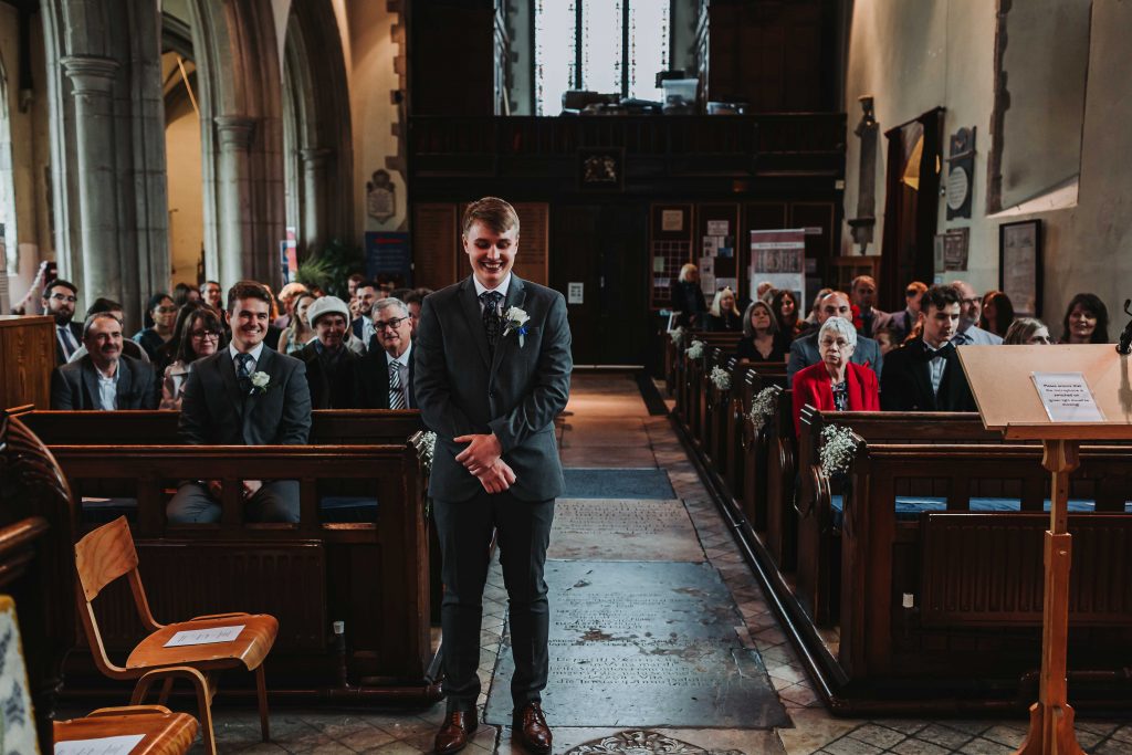 groom waiting for bride at altar