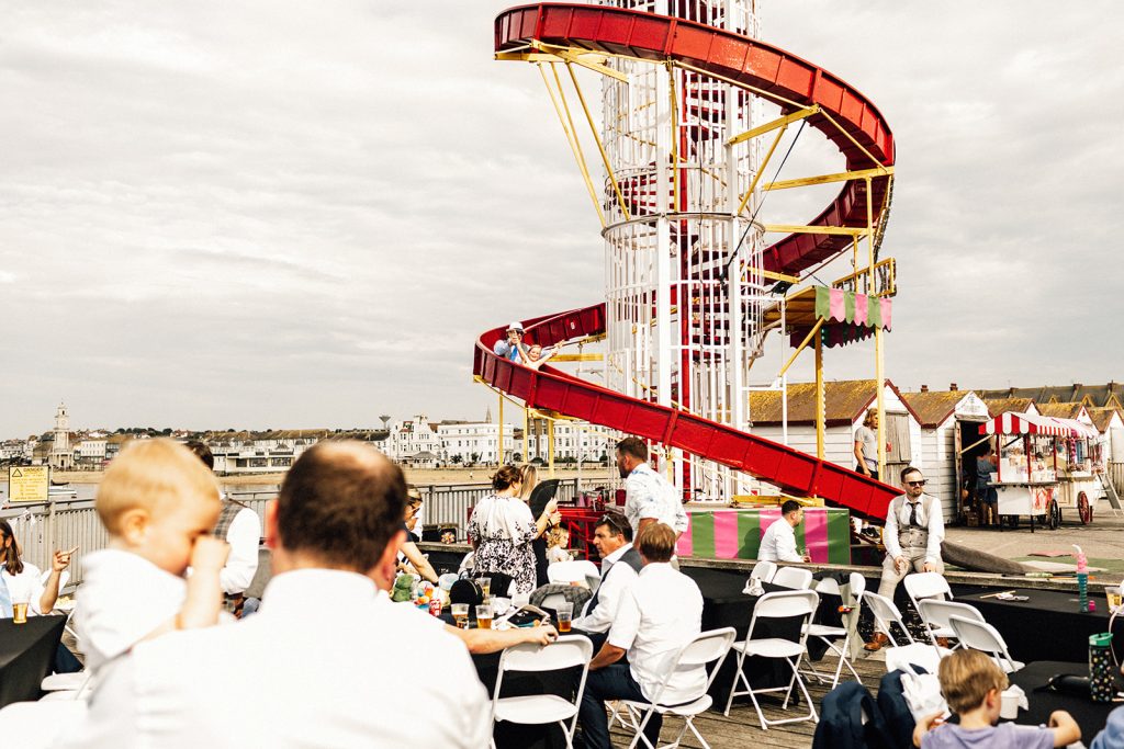 guests on helter skelter at beach hut wedding venue