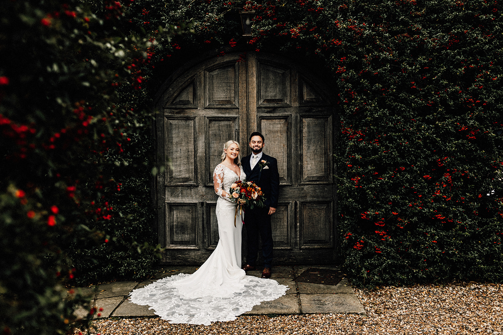 couple portrait in front of big oak doors at winters barns wedding venue