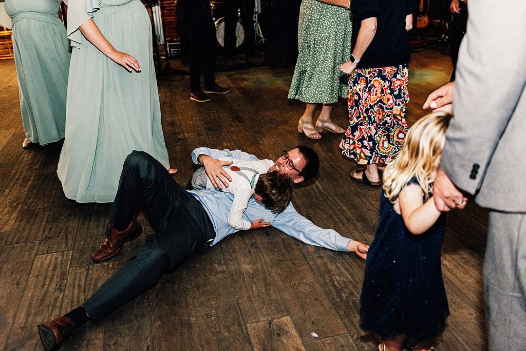 small child and adult lying on the floor on the dancefloor laughing