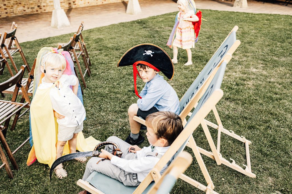 kids at wedding dressed up with rainbow colours and pirate hat and sword