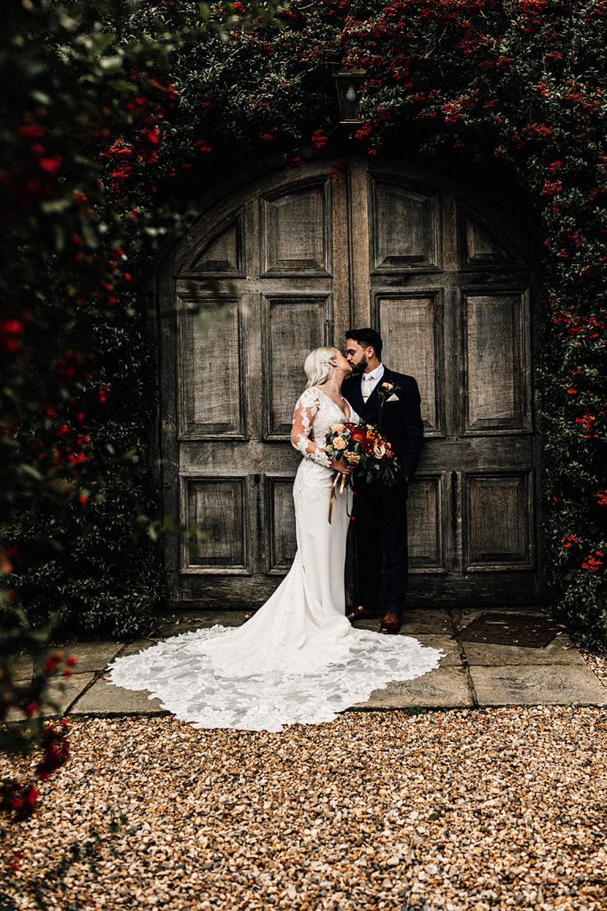 bride and groom portrait in front of the iconic doors at winters barns wedding venue