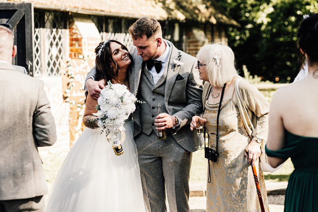 bride and groom chatting with wedding guest