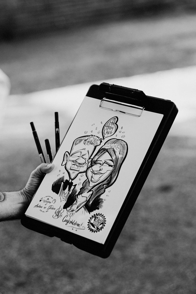 caricature picture being held of bride and groom by artist