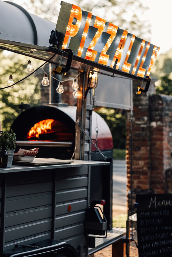 pizza oven at wedding reception with flames inside