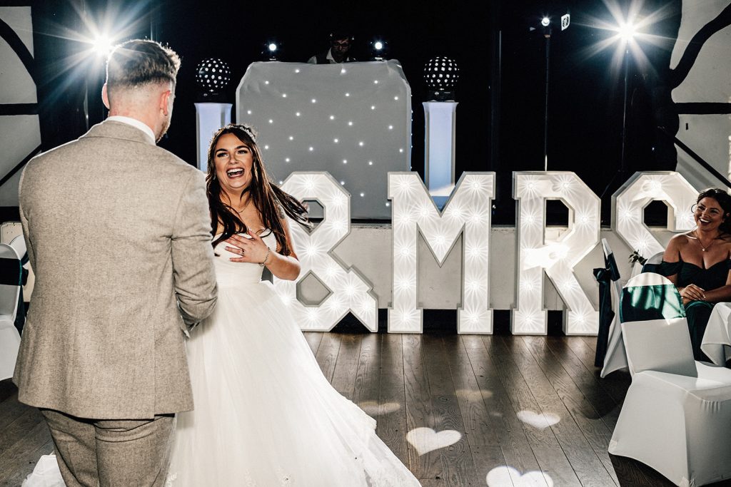 bride and groom dancing and smiling