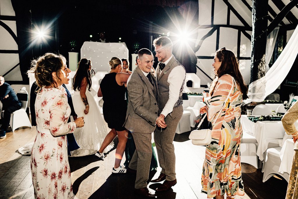 groom and best man dancing on dance floor