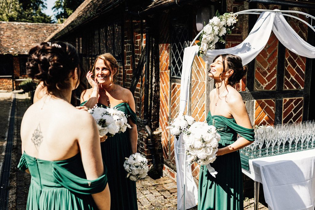 bridesmaids dressed in green chatting and laughing