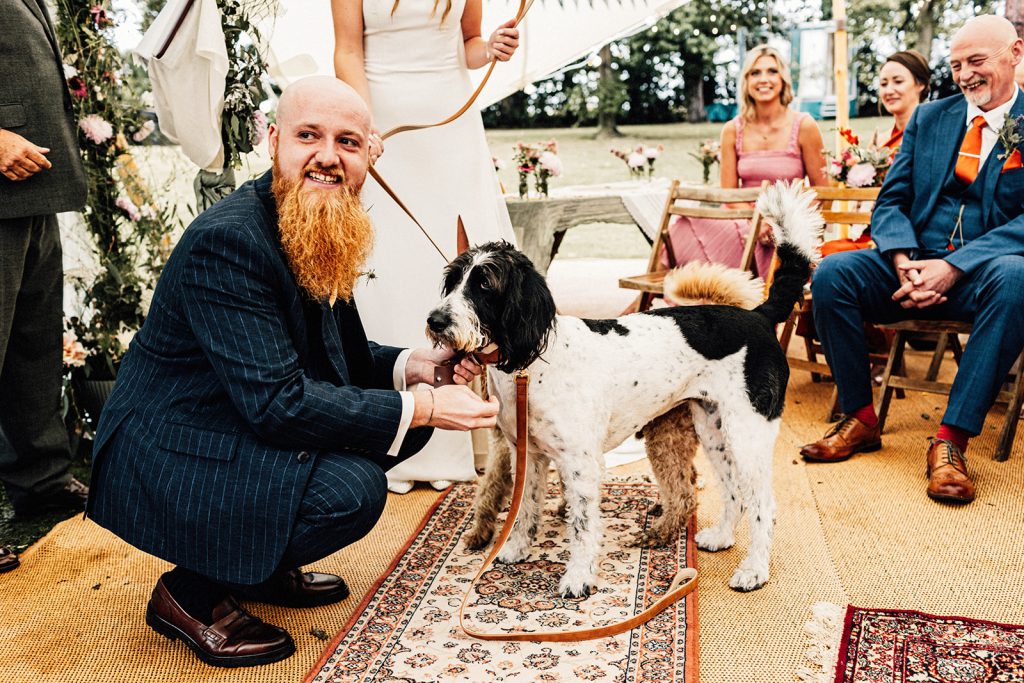 Groom taking rings from his dogs who are the ring bearers at Guston Court Wedding Photographer