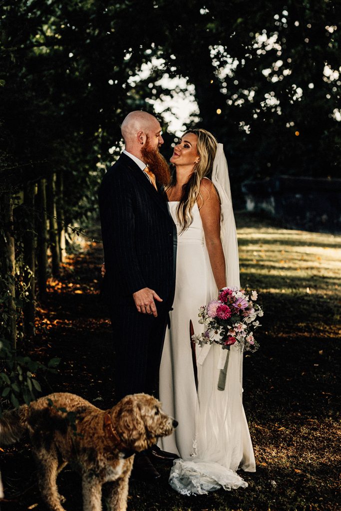 bride and groom portrait with their dog taken by Kent Wedding photographer