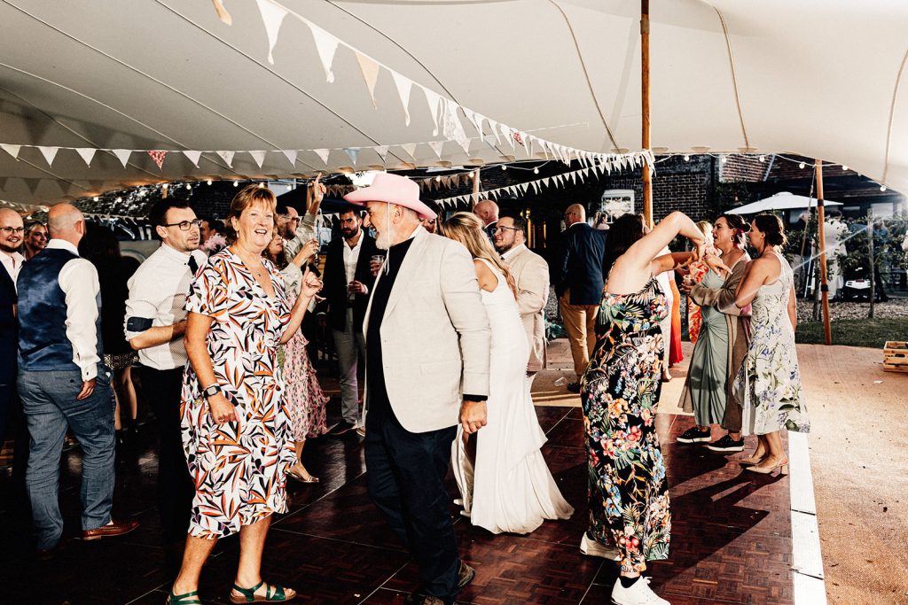 wedding guests dancing in tipi at Guston Court wedding venue