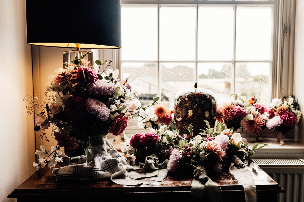 wedding flowers on dresser in natural light through window at Guston court