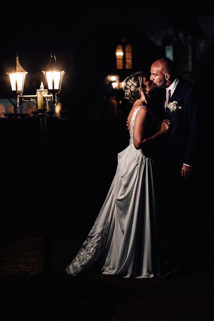 wedding portrait at night in grounds of Bilsington Priory