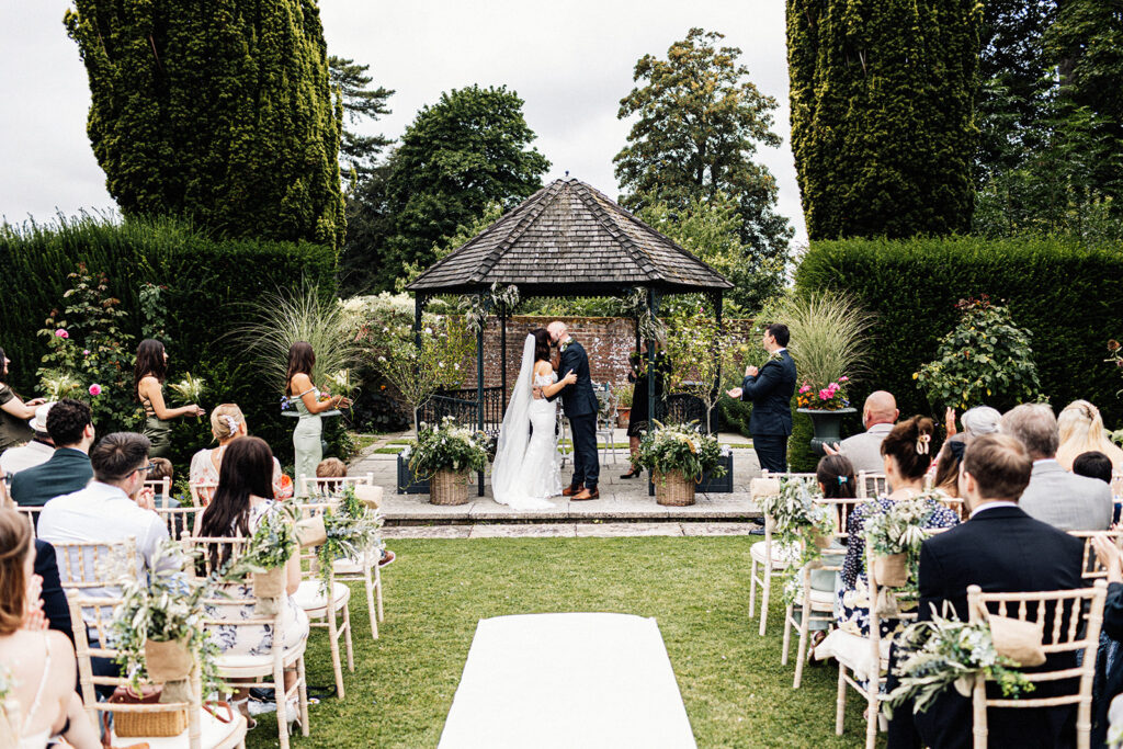 wedding ceremony in the gardens of Swarling Manor wedding venue.